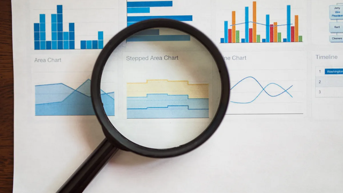 magnifying glass over charts on a report