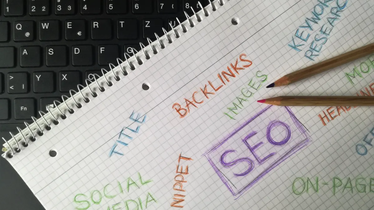 SEO keyword planning notes in a notebook on a desk